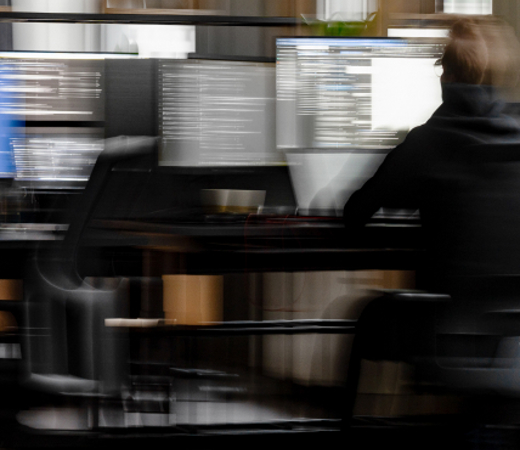 A 7N male staff member working in the office on his computer